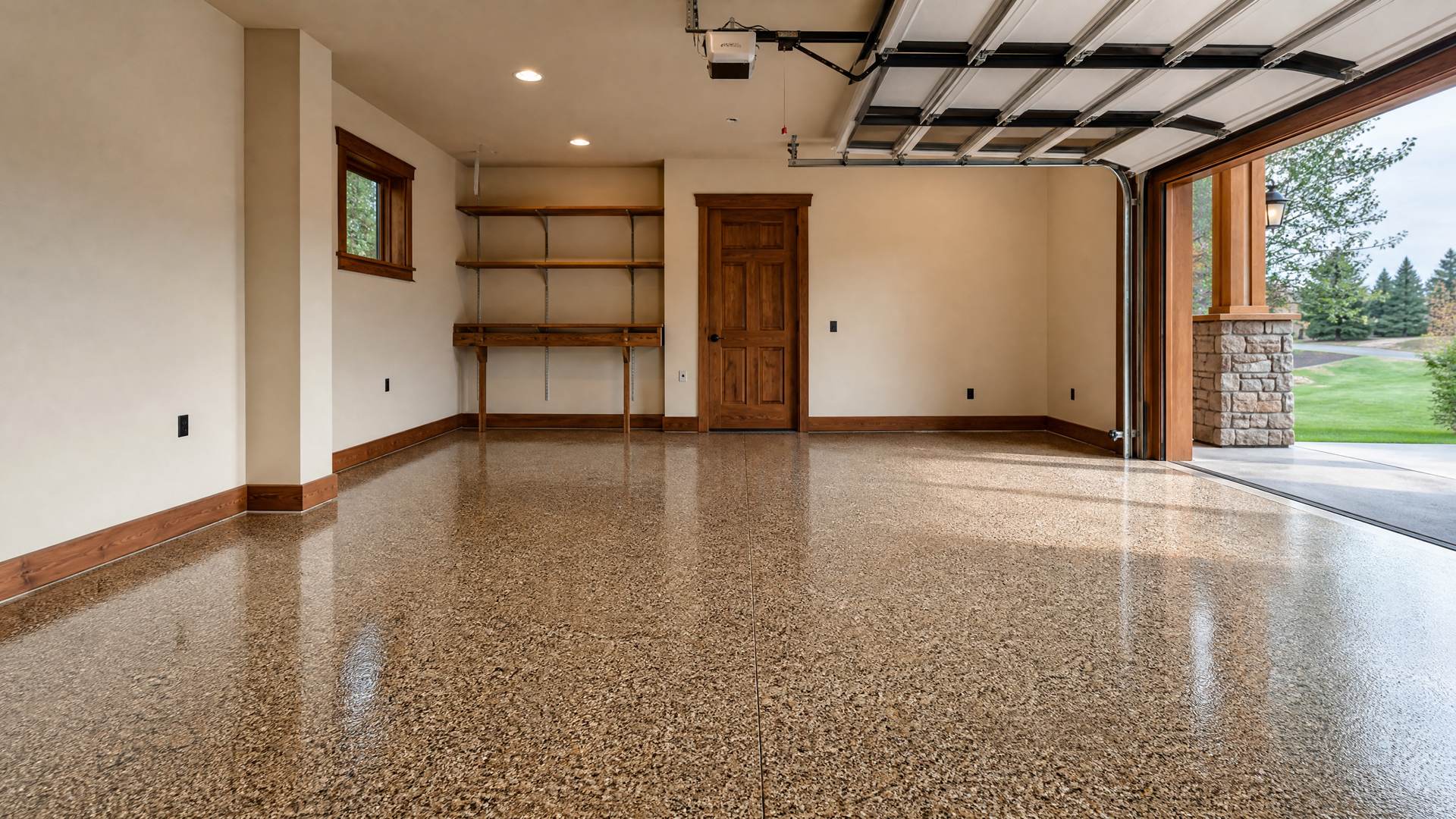 A Craftsman-style garage with a speckled flake epoxy floor and wood trim